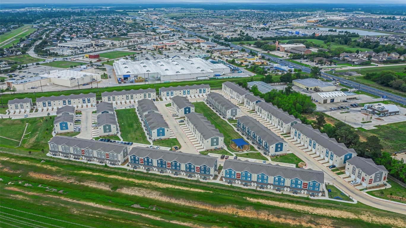 21155 Gosling Road, Unit 15 AB Spring, TX 77388 - Photo 26 of 30 Capture the essence of community living with this inviting drone shot showcasing charming townhouses and a vibrant playground, perfect for families seeking a welcoming neighborhood.