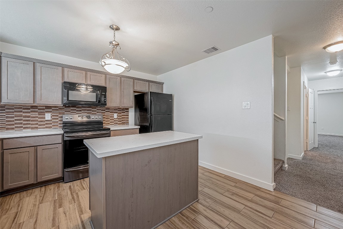 21155 Gosling Road, Unit 15 AB Spring, TX 77388 - Photo 9 of 30 Modern kitchen with ample natural light, featuring sleek cabinetry, stainless steel appliances, and a stylish tile backsplash.