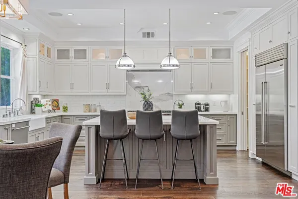 a view of kitchen with dining area refrigerator and wooden floor