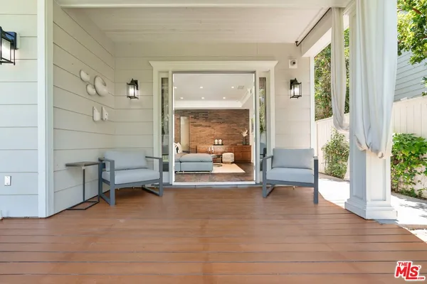 a view of front door and porch with wooden floor