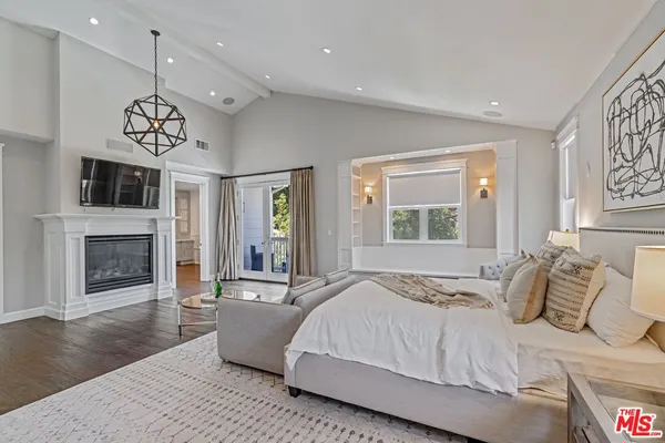 a spacious bedroom with a large bed and a fireplace