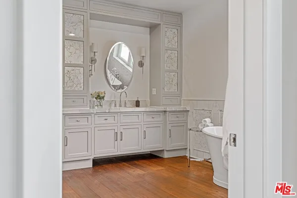 a spacious bathroom with a granite countertop double vanity sink and a mirror
