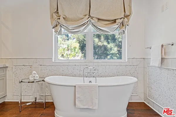 a bathroom with a bathtub and a window