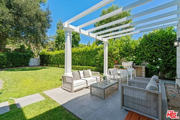 a view of a patio with couches chairs and a big yard