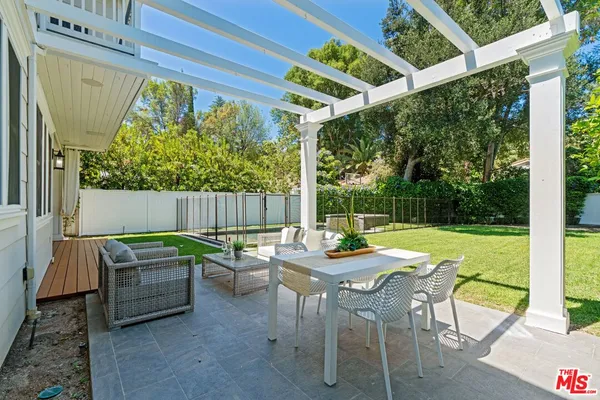 a view of an outdoor sitting area with furniture and garden view