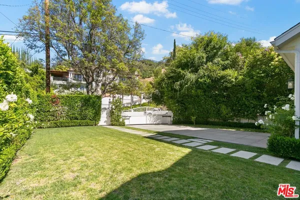 a view of a big yard with large trees