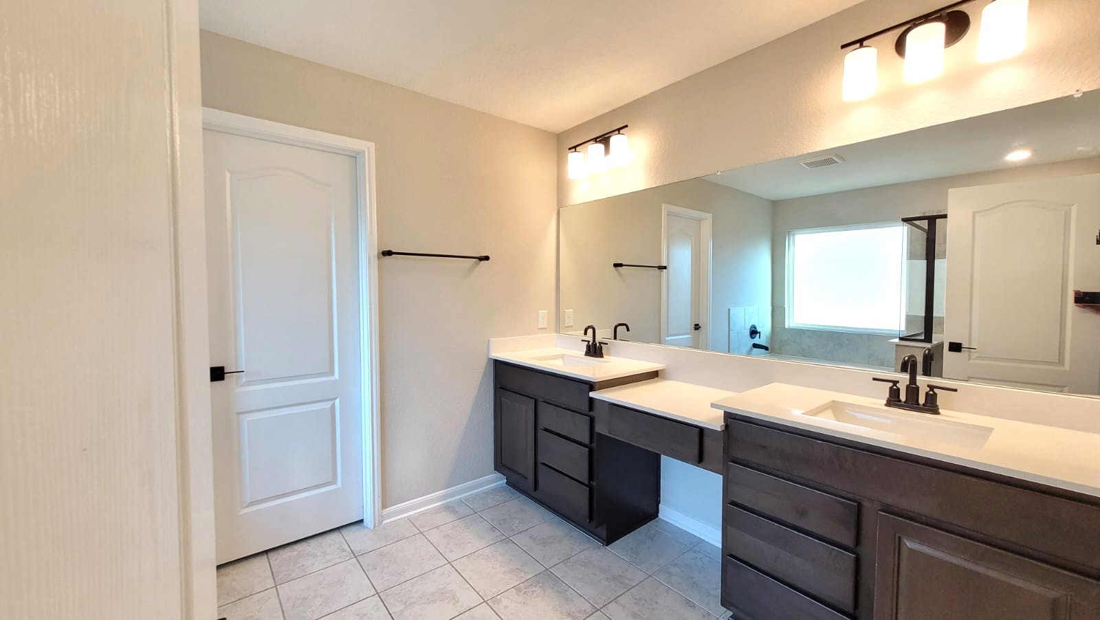 5704 Bluebonnet Lane Rosenberg, TX 77469 - Photo 14 of 34 a bathroom with a double vanity sink and mirror