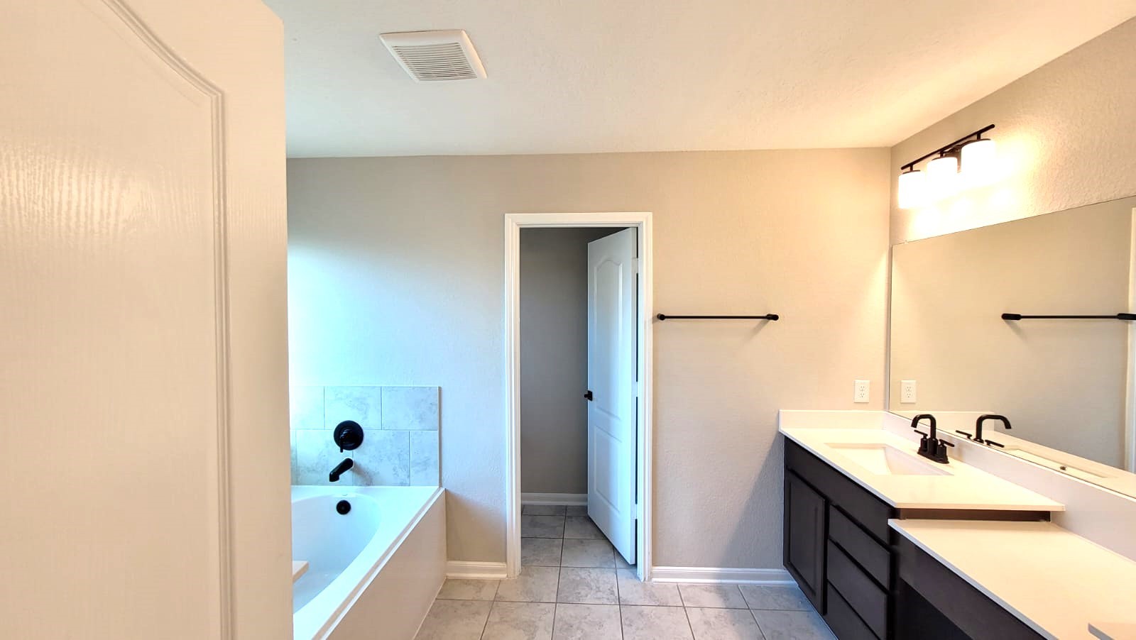 5704 Bluebonnet Lane Rosenberg, TX 77469 - Photo 17 of 34 a bathroom with a tub sink and mirror