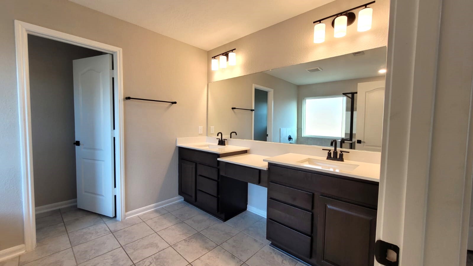 5704 Bluebonnet Lane Rosenberg, TX 77469 - Photo 18 of 34 a bathroom with a double vanity sink and mirror