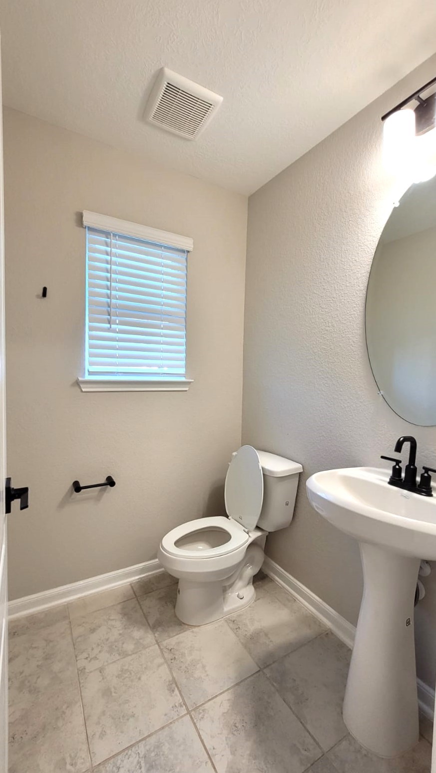 5704 Bluebonnet Lane Rosenberg, TX 77469 - Photo 20 of 34 a bathroom with a toilet sink and mirror