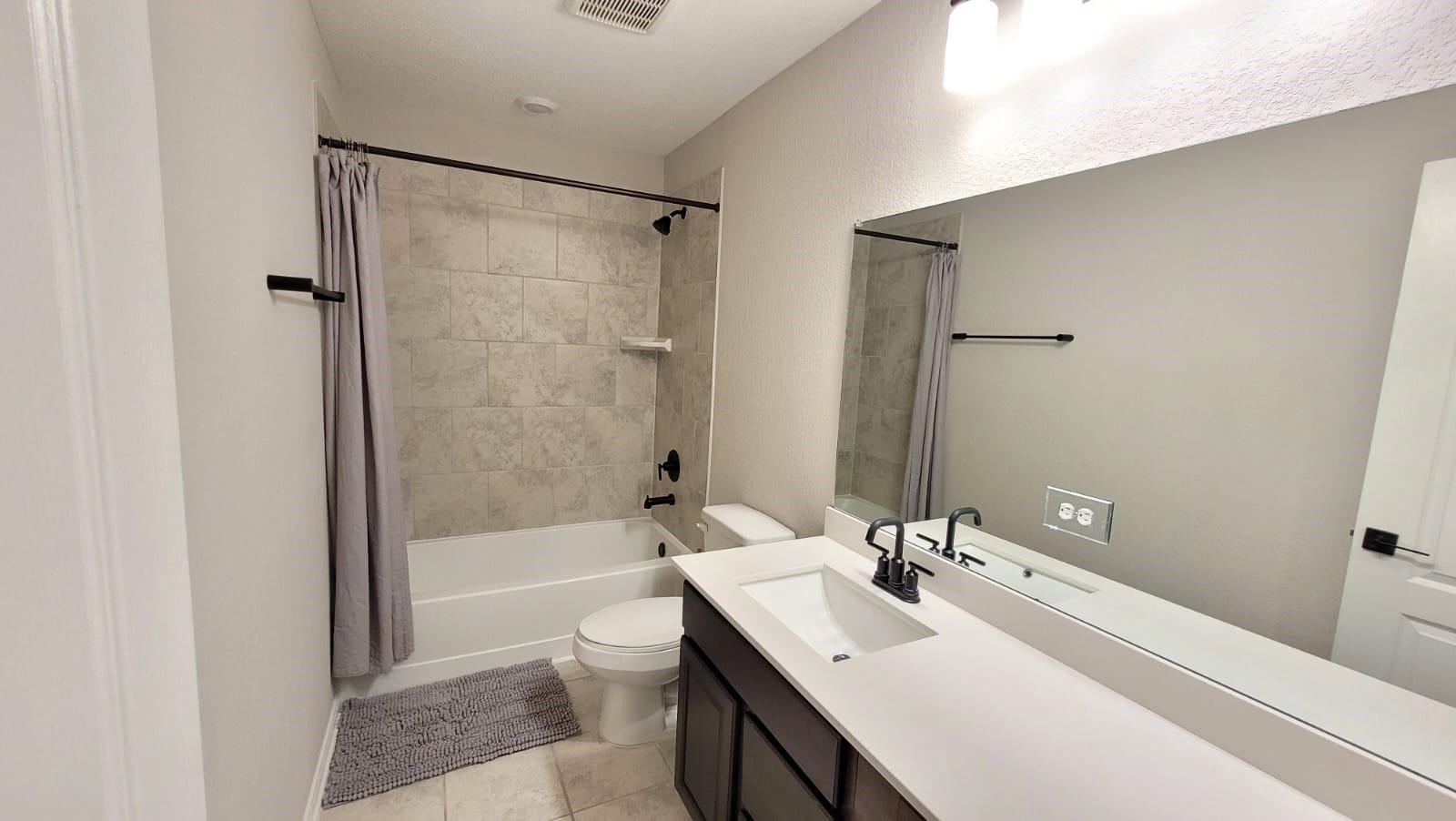 5704 Bluebonnet Lane Rosenberg, TX 77469 - Photo 29 of 34 a bathroom with a bathtub shower sink vanity mirror and toilet
