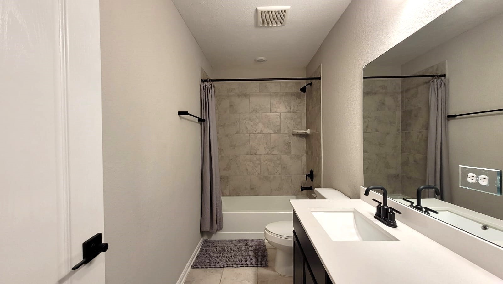 5704 Bluebonnet Lane Rosenberg, TX 77469 - Photo 30 of 34 a bathroom with a sink a tub and a mirror