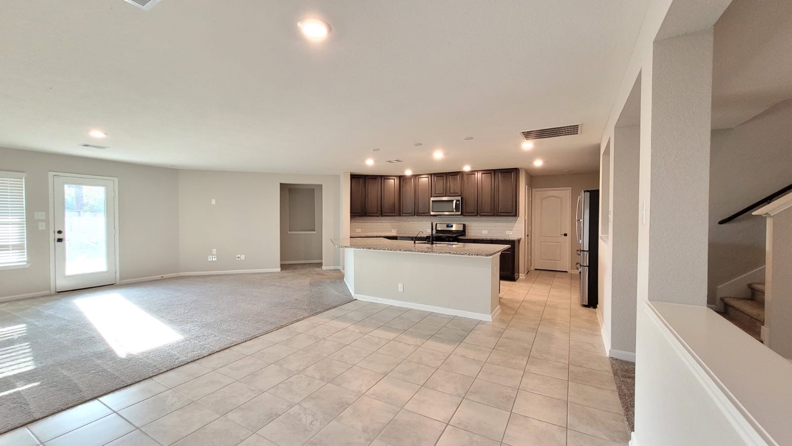 5704 Bluebonnet Lane Rosenberg, TX 77469 - Photo 4 of 34 a view of kitchen with kitchen island a sink stainless steel appliances and cabinets