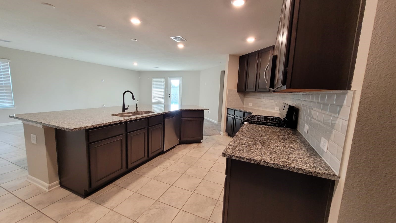 5704 Bluebonnet Lane Rosenberg, TX 77469 - Photo 8 of 34 a kitchen with a sink and a stove top oven with wooden floor
