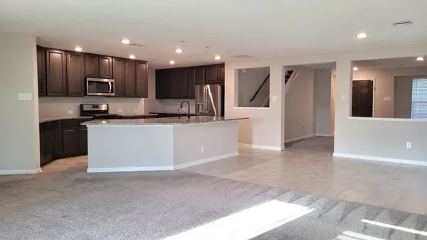 a kitchen with stainless steel appliances granite countertop a refrigerator and a sink
