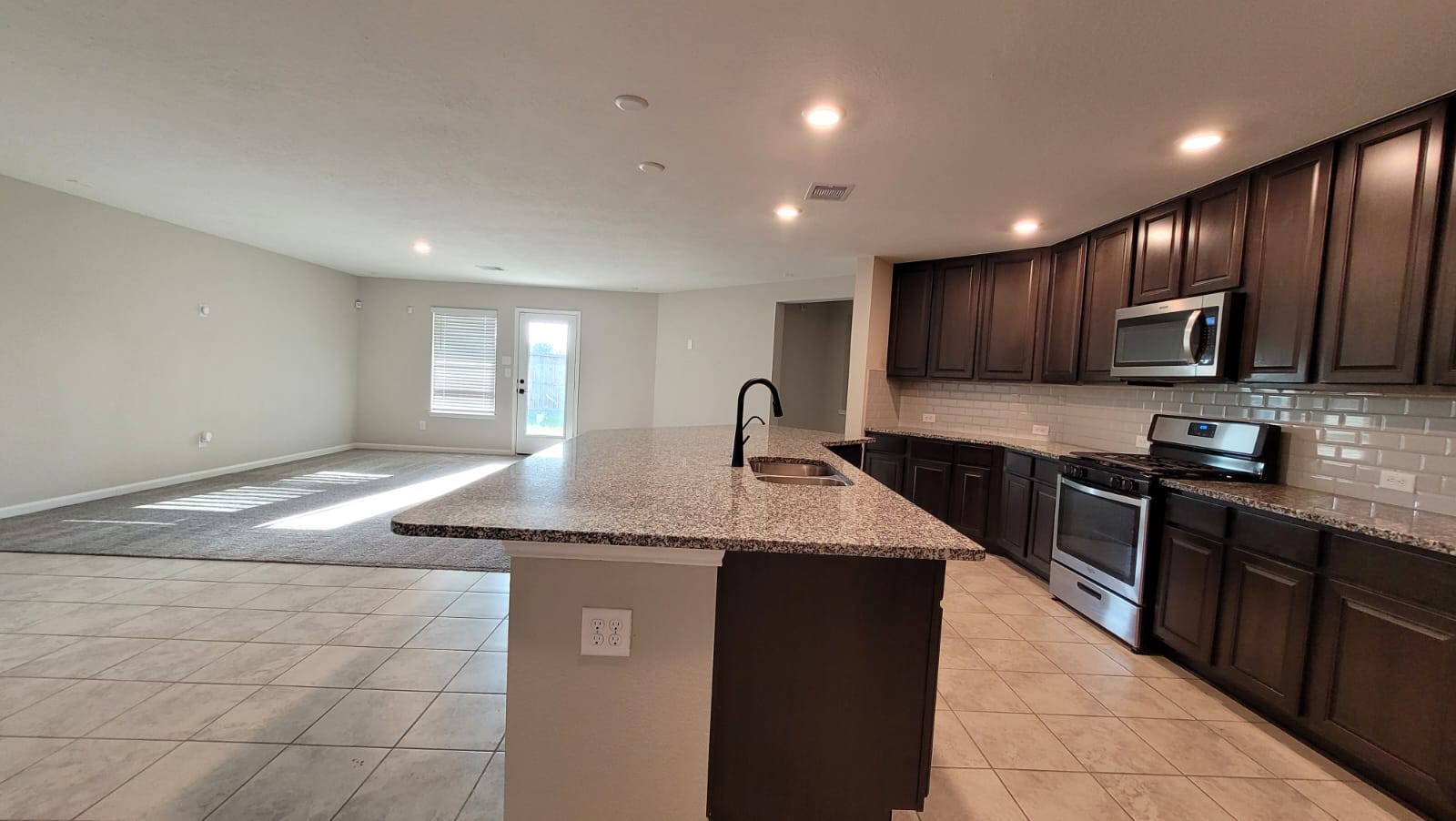 5704 Bluebonnet Lane Rosenberg, TX 77469 - Photo 10 of 34 a kitchen with stainless steel appliances granite countertop a sink stove and cabinets