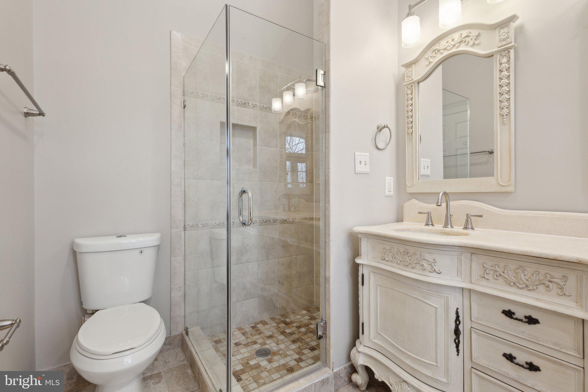 8802 Eagle Rock Lane Springfield, VA 22153 - Photo 12 of 18 a bathroom with a granite countertop toilet sink shower and mirror