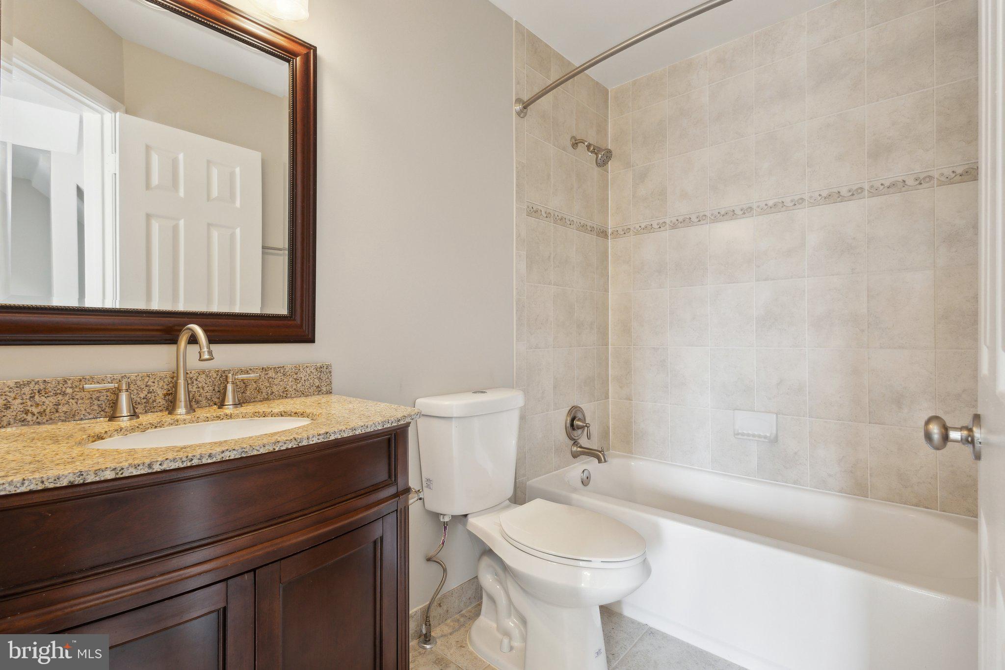 8802 Eagle Rock Lane Springfield, VA 22153 - Photo 15 of 18 a bathroom with a sink a toilet and a bathtub