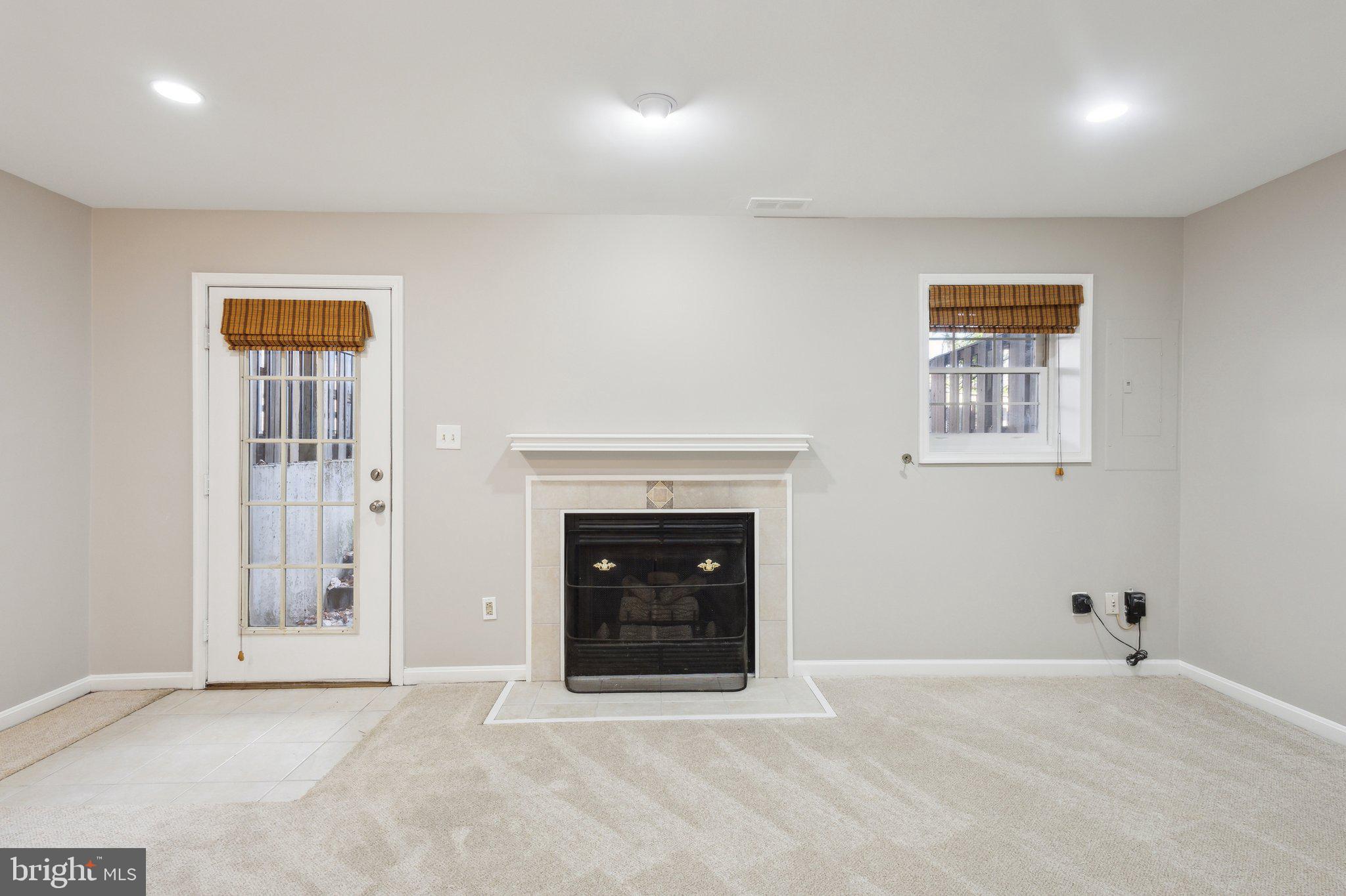 8802 Eagle Rock Lane Springfield, VA 22153 - Photo 16 of 18 an empty room with windows and fireplace