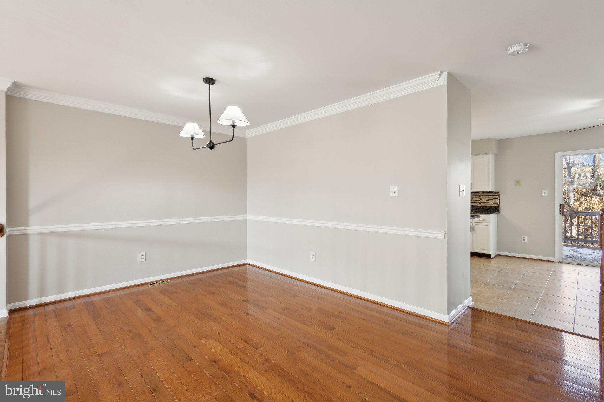8802 Eagle Rock Lane Springfield, VA 22153 - Photo 3 of 18 wooden floor in an empty room with a window
