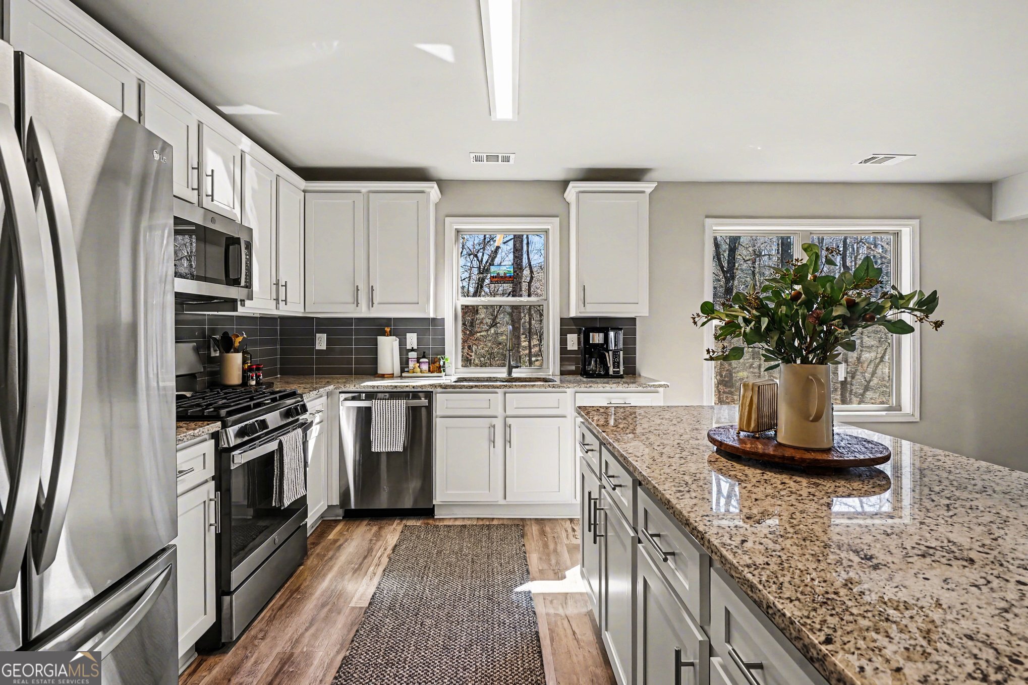 994 Lakeview Drive Commerce, GA 30529 - Photo 14 of 42 a kitchen with stainless steel appliances granite countertop a sink stove and refrigerator