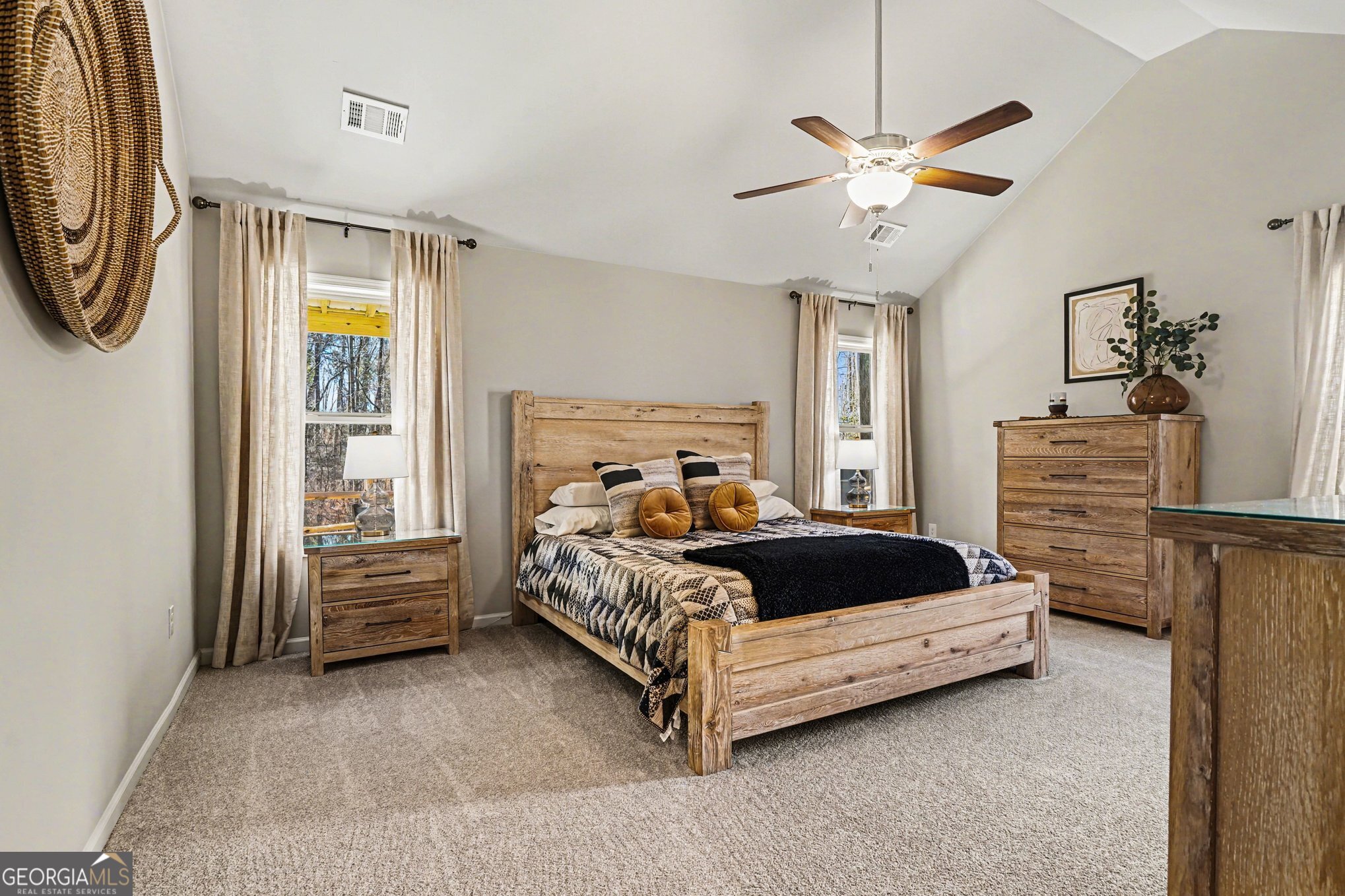 994 Lakeview Drive Commerce, GA 30529 - Photo 17 of 42 a bed sitting in a bedroom next to a window and a chandelier