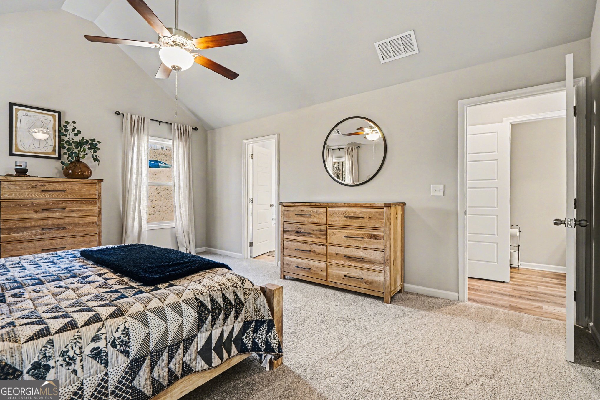 994 Lakeview Drive Commerce, GA 30529 - Photo 19 of 42 a bedroom with a bed a dresser and a chandelier