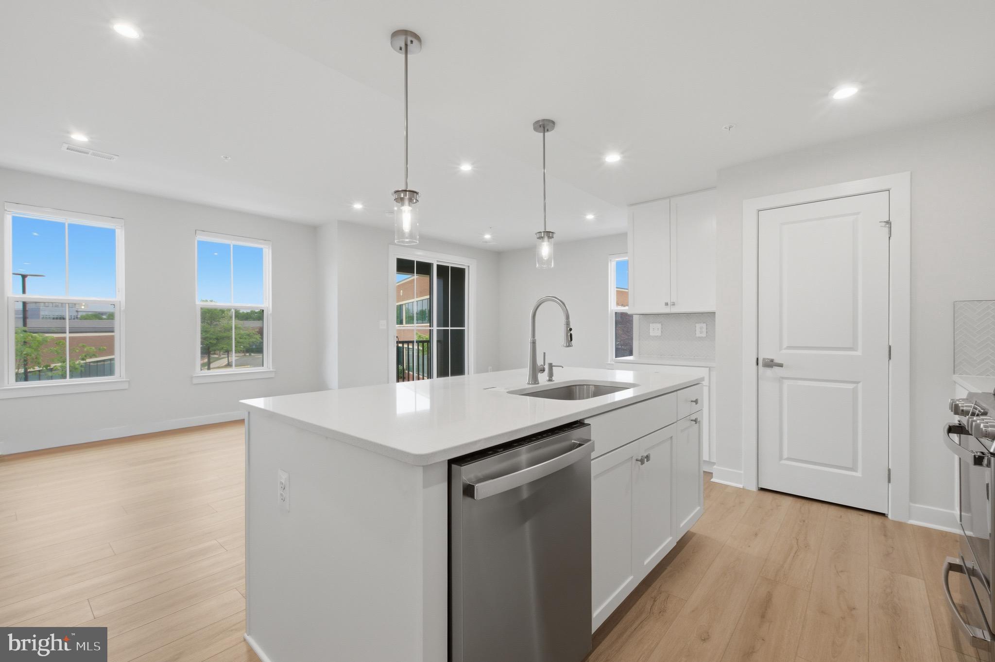 14421 Albemarle Point Place Chantilly, VA 20151 - Photo 11 of 25 a kitchen with a sink a center island a counter space and a window