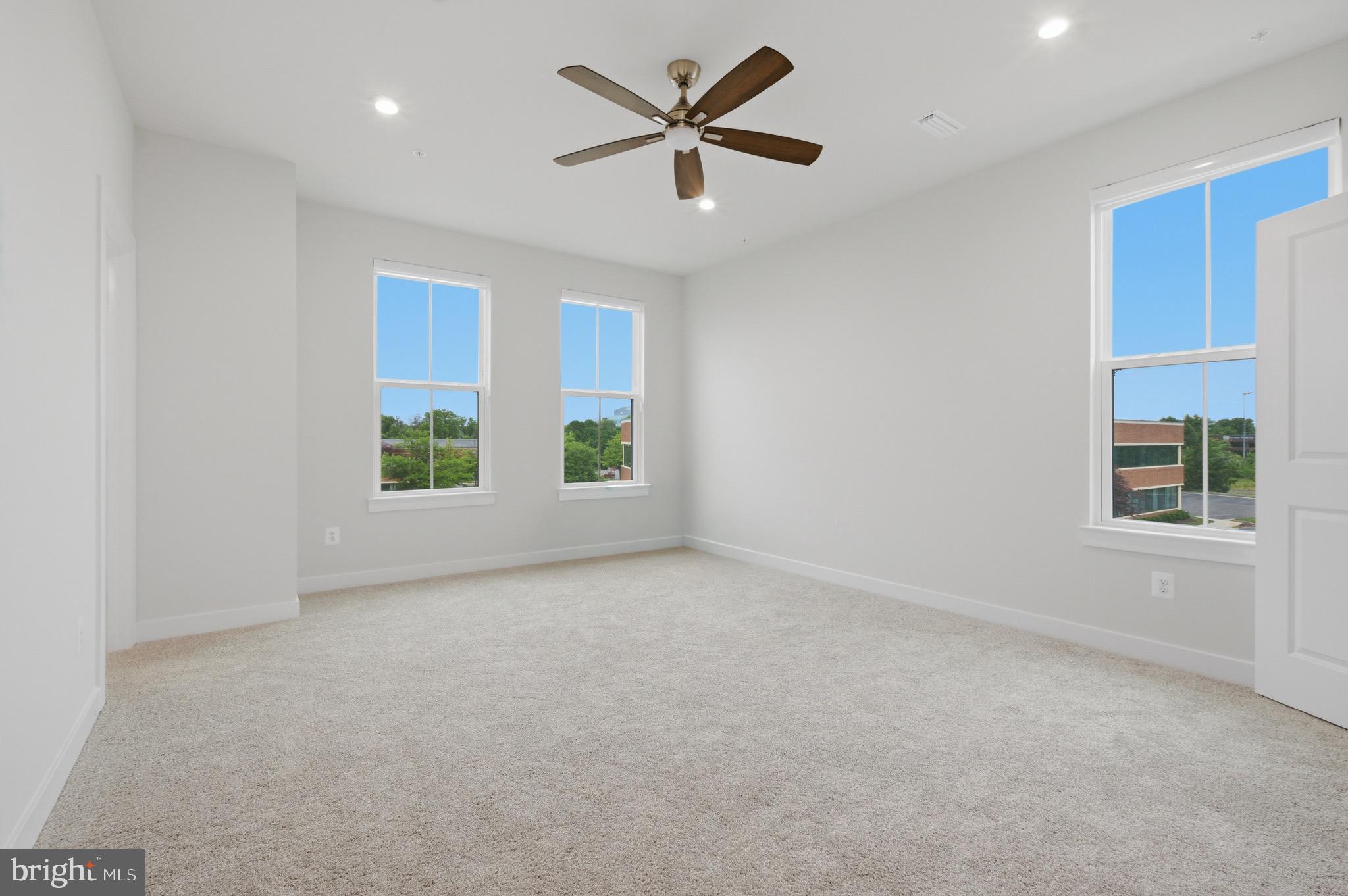 14421 Albemarle Point Place Chantilly, VA 20151 - Photo 16 of 25 an empty room with windows and ceiling fan