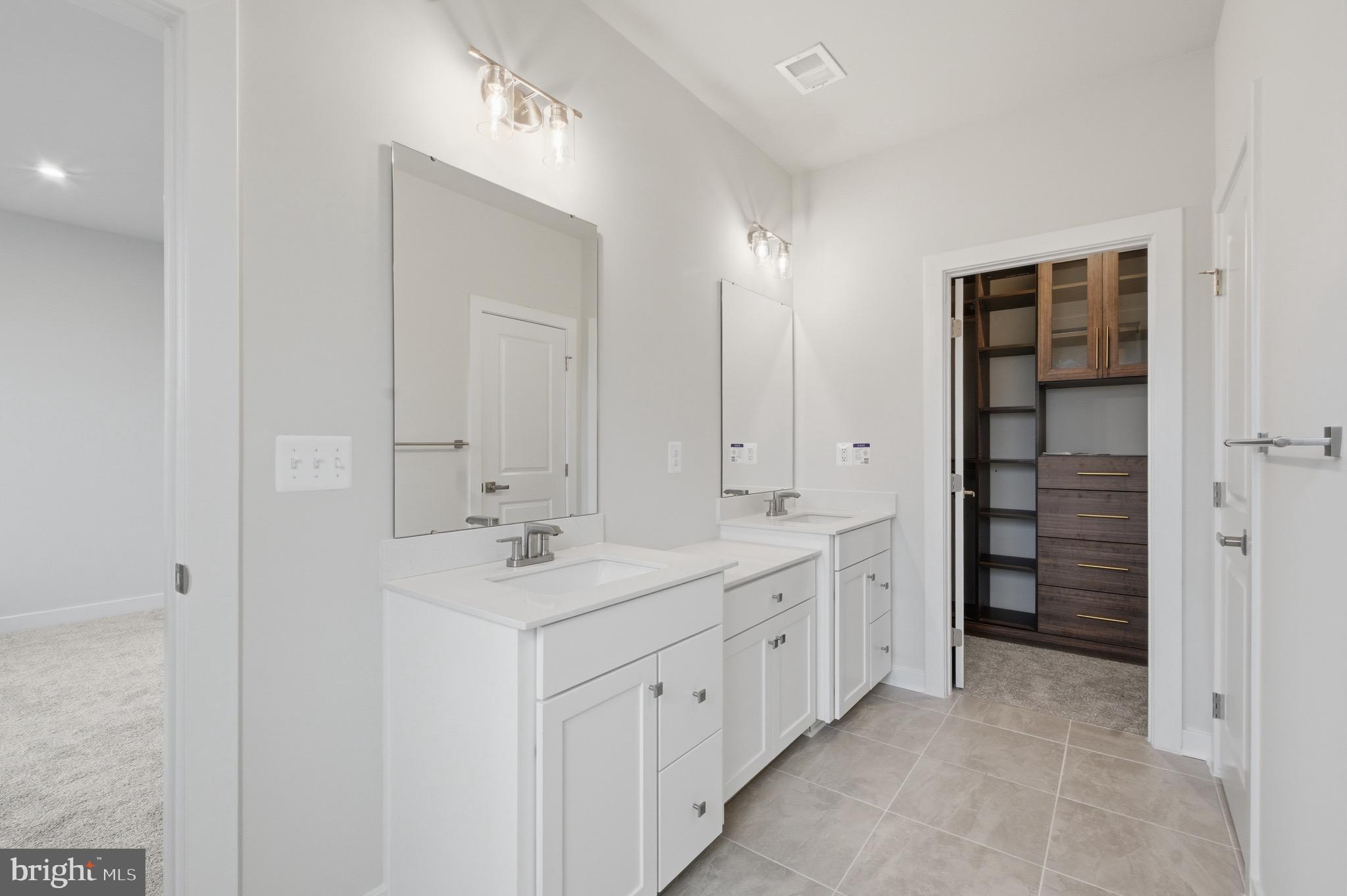 14421 Albemarle Point Place Chantilly, VA 20151 - Photo 19 of 25 a bathroom with a double vanity sink and a