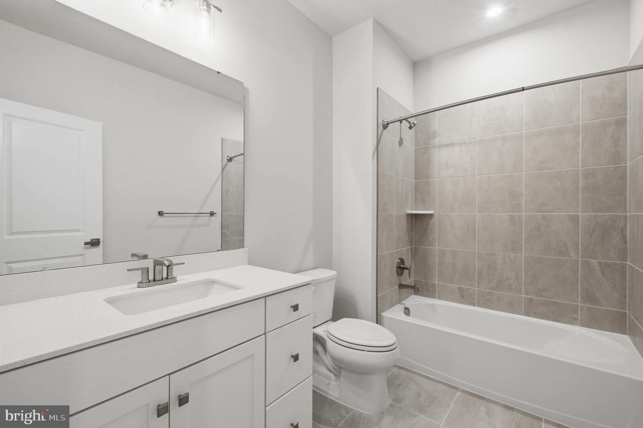 14421 Albemarle Point Place Chantilly, VA 20151 - Photo 20 of 25 a bathroom with a sink a mirror toilet and bathtub