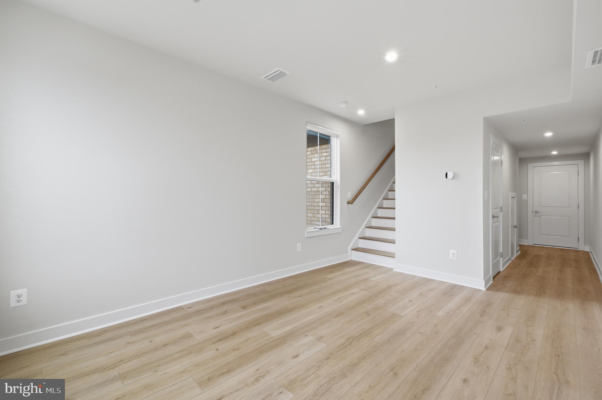 14421 Albemarle Point Place Chantilly, VA 20151 - Photo 3 of 25 a view of an empty room with wooden floor and stairs