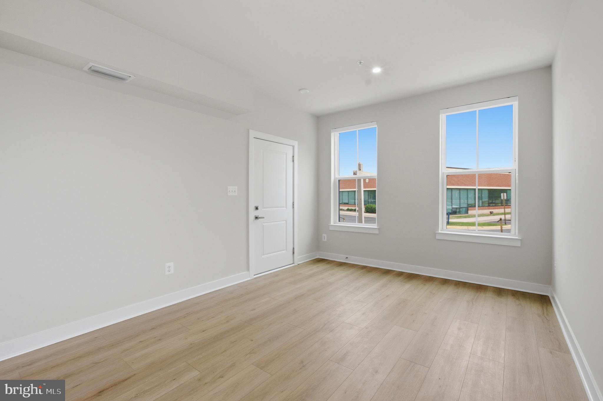 14421 Albemarle Point Place Chantilly, VA 20151 - Photo 4 of 25 a view of an empty room with wooden floor and a window