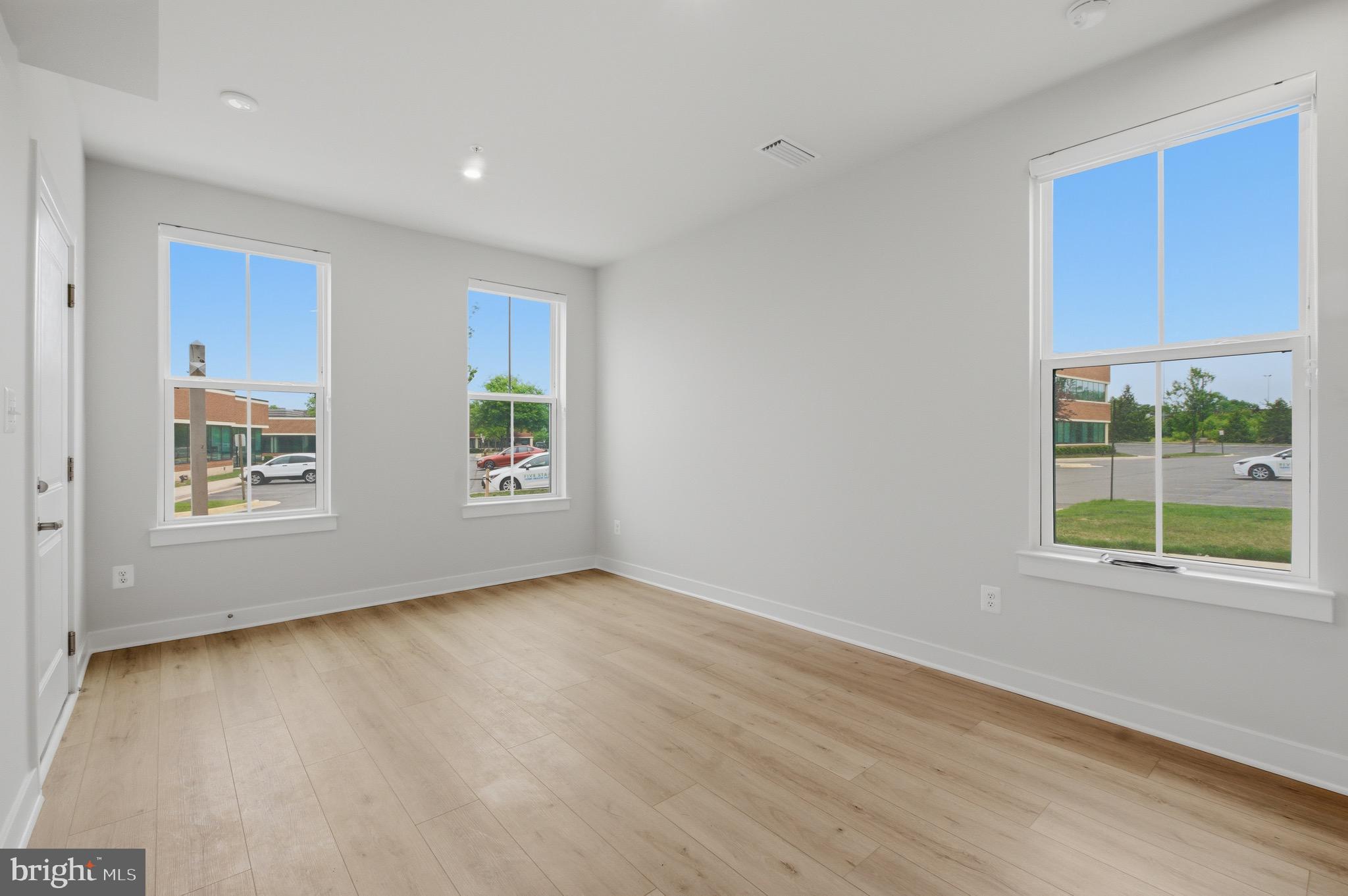 14421 Albemarle Point Place Chantilly, VA 20151 - Photo 5 of 25 a view of an empty room with wooden floor and a window