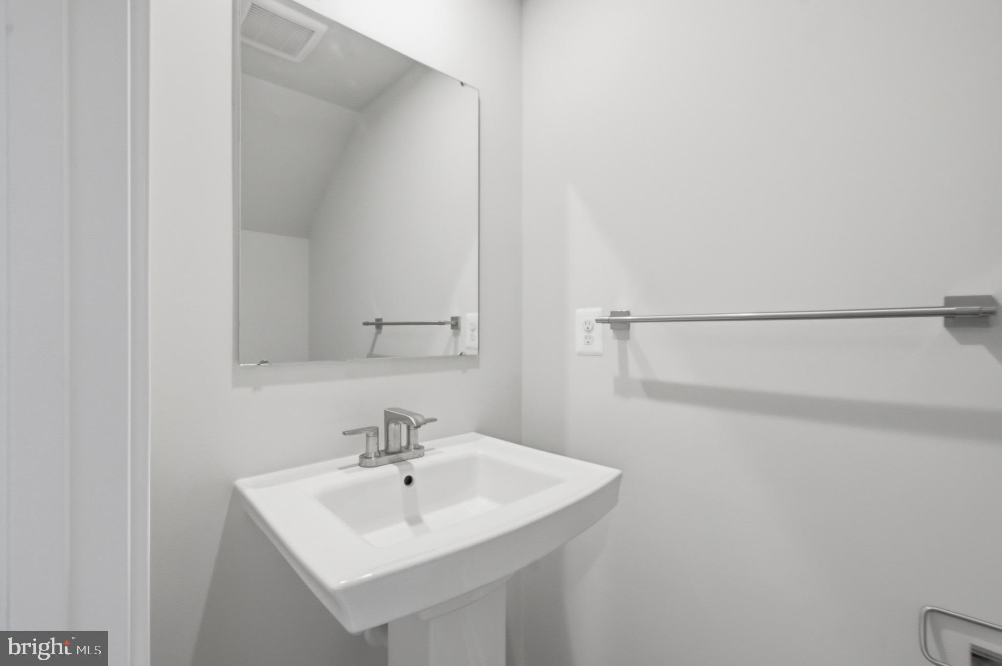 14421 Albemarle Point Place Chantilly, VA 20151 - Photo 6 of 25 a bathroom with a sink and a mirror