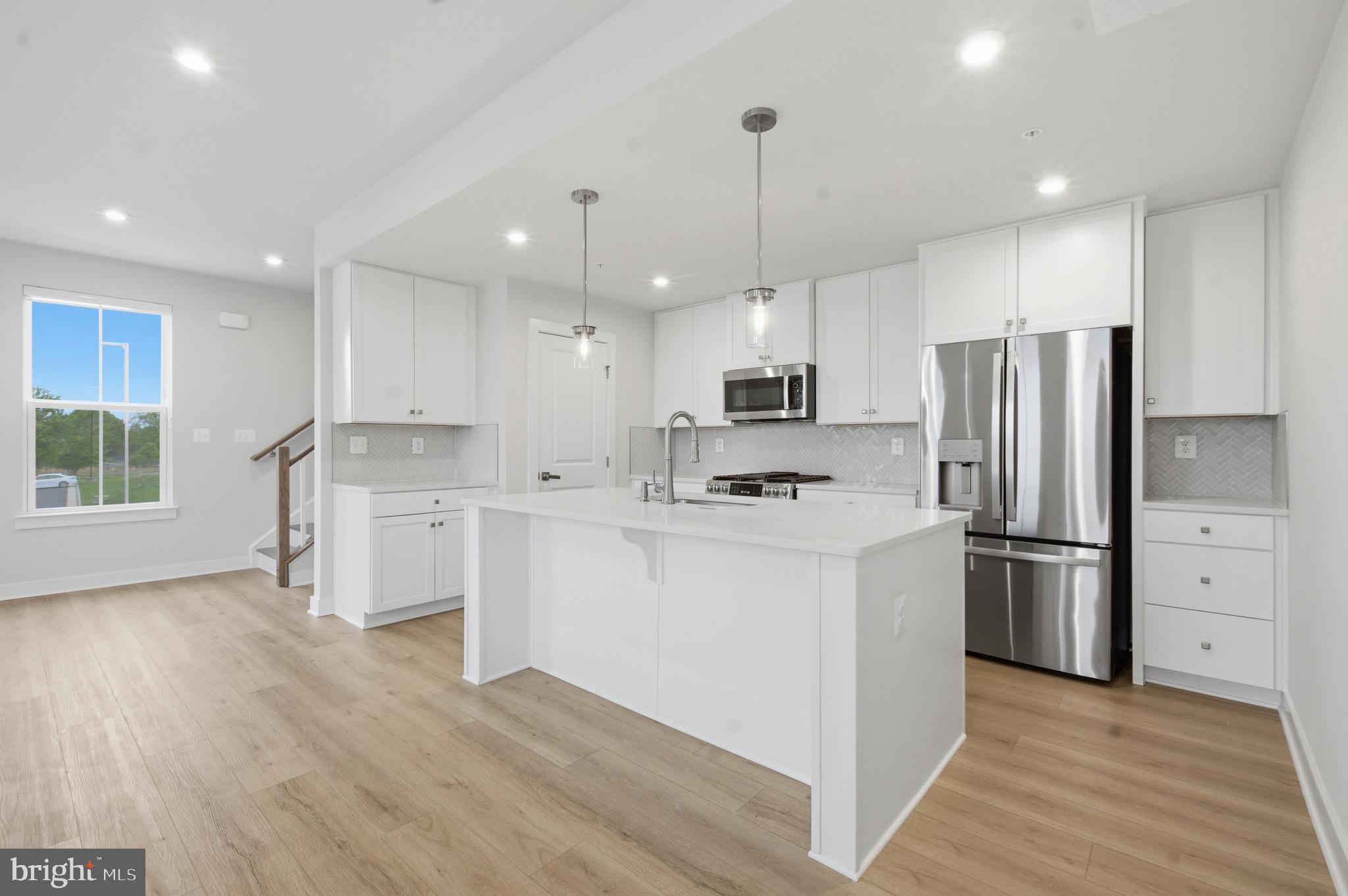 14421 Albemarle Point Place Chantilly, VA 20151 - Photo 9 of 25 a kitchen with white cabinets and stainless steel appliances