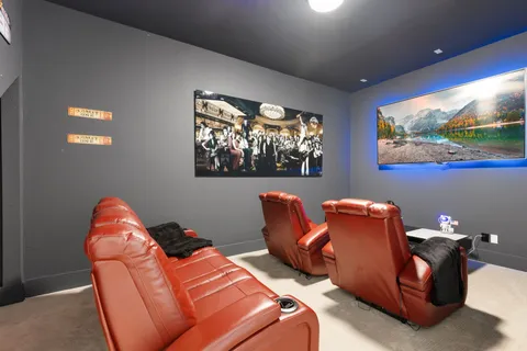 a living room with furniture a flat screen tv and a painting on the wall