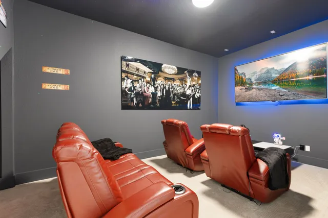 a living room with furniture a flat screen tv and a painting on the wall