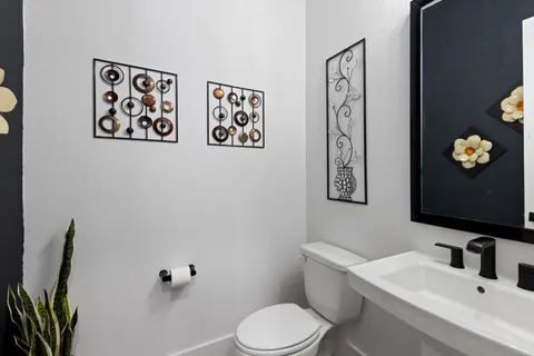 a bathroom with a toilet sink and mirror