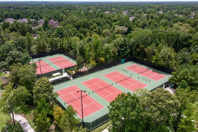 an aerial view of a tennis ground and a yard