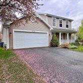 a front view of house with yard and trees