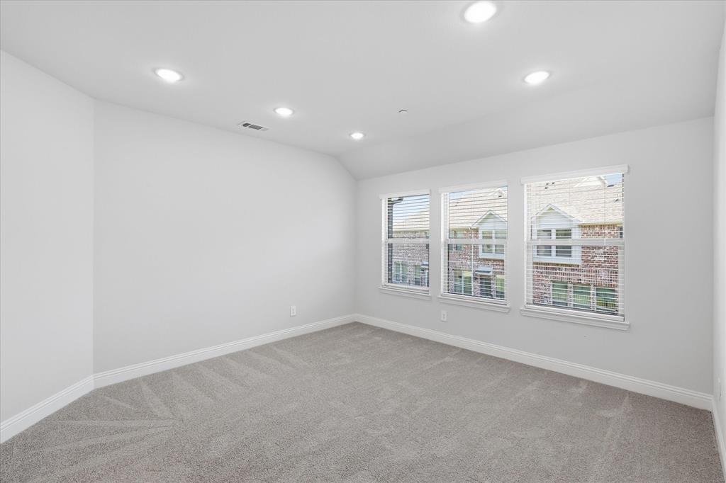 519 Sequoia Street Allen, TX 75002 - Photo 29 of 38 Room featuring three windows with blinds, recessed lighting, neutral wall paint, white baseboards, and gray patterned carpet
