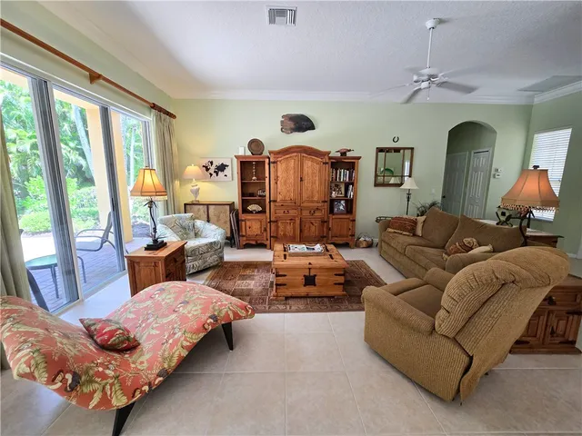 a living room with furniture fireplace and a large window