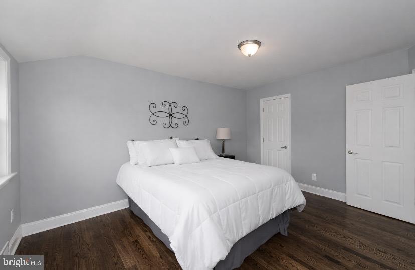 1224 Winston Avenue Baltimore, MD 21239 - Photo 15 of 26 a bedroom with a bed and wooden floor