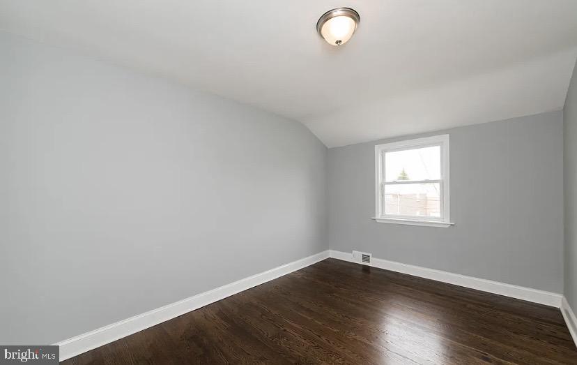 1224 Winston Avenue Baltimore, MD 21239 - Photo 20 of 26 an empty room with wooden floor and windows