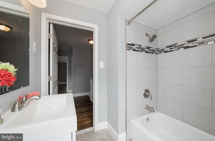 1224 Winston Avenue Baltimore, MD 21239 - Photo 21 of 26 a bathroom with a tub a sink and mirror