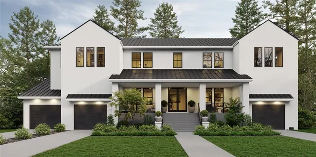 a front view of a house with a yard and potted plants