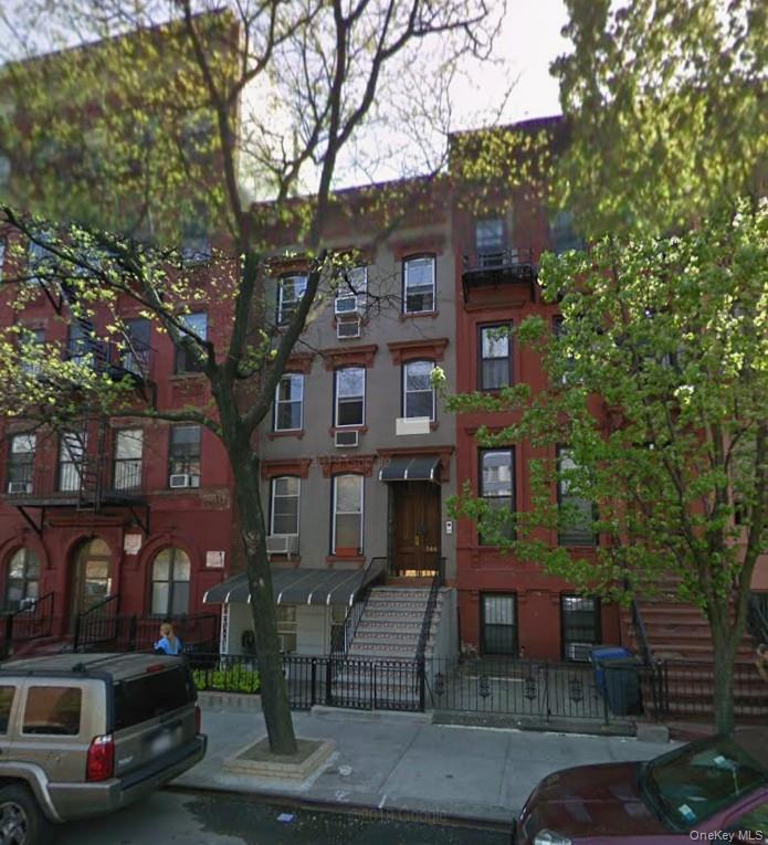 View of apartment building / complex featuring cooling unit