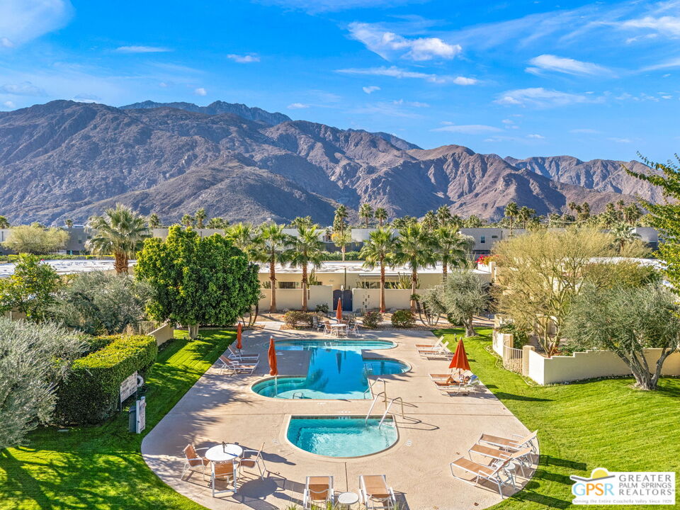 1115 East Alejo Road Palm Springs, CA 92262 - Photo 1 of 40 a view of a swimming pool with a table and chairs
