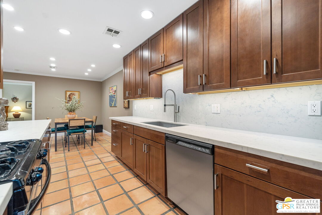 1115 East Alejo Road Palm Springs, CA 92262 - Photo 22 of 40 a kitchen with a sink and cabinets